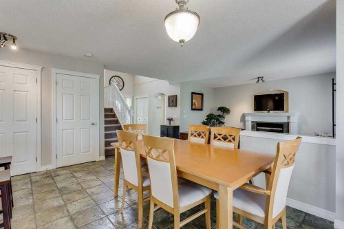 249 West Lakeview Place, Chestermere, AB - Indoor Photo Showing Dining Room With Fireplace