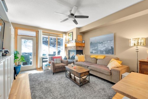 612-107 Armstrong Place, Canmore, AB - Indoor Photo Showing Living Room With Fireplace