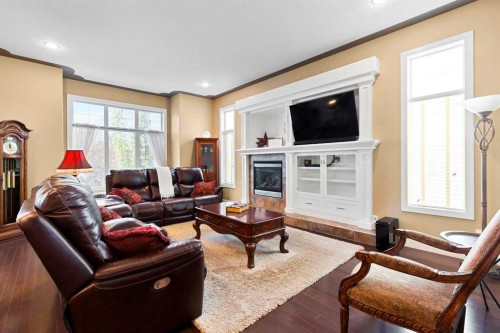 117 Kingsland Court Se, Airdrie, AB - Indoor Photo Showing Living Room With Fireplace
