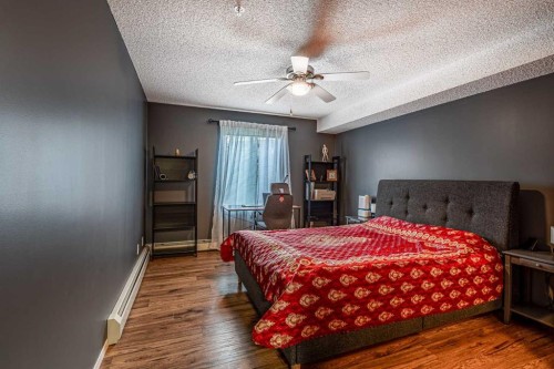 8213-304 Mackenzie Way Sw, Airdrie, AB - Indoor Photo Showing Bedroom