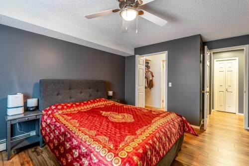 8213-304 Mackenzie Way Sw, Airdrie, AB - Indoor Photo Showing Bedroom