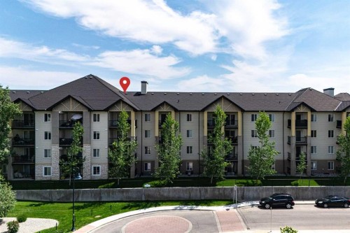 8213-304 Mackenzie Way Sw, Airdrie, AB - Outdoor With Balcony With Facade