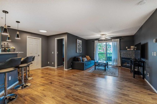 8213-304 Mackenzie Way Sw, Airdrie, AB - Indoor With Fireplace