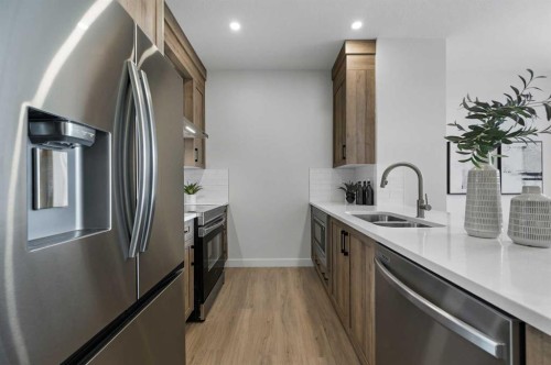 2194 Bayview Drive Sw, Airdrie, AB - Indoor Photo Showing Kitchen With Stainless Steel Kitchen With Double Sink With Upgraded Kitchen