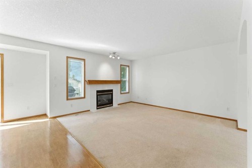 34 Tuscarora Way Nw, Calgary, AB - Indoor Photo Showing Other Room With Fireplace