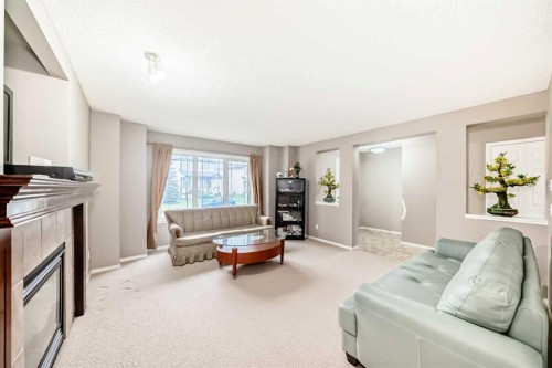135 Copperstone Grove Se, Calgary, AB - Indoor Photo Showing Living Room With Fireplace