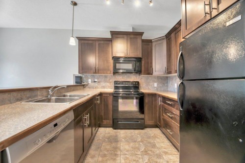 420 Ranch Ridge Meadow, Strathmore, AB - Indoor Photo Showing Kitchen With Double Sink