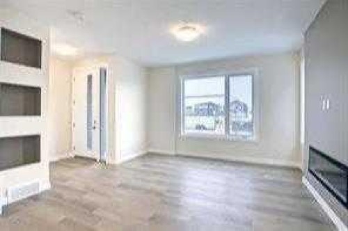 117 Cobblestone Gate Sw, Airdrie, AB - Indoor With Fireplace