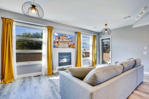 4735 17 Avenue Nw, Calgary, AB - Indoor Photo Showing Living Room With Fireplace