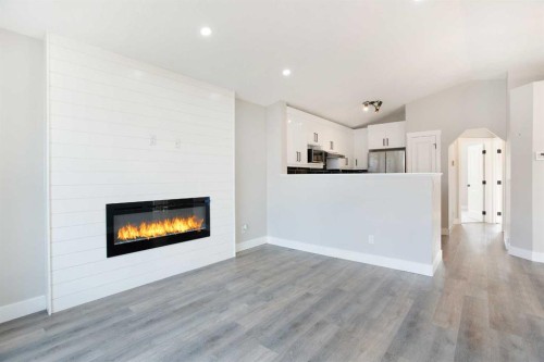 125 Martinpark Way Ne, Calgary, AB - Indoor Photo Showing Living Room With Fireplace