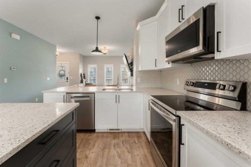 228 Ravenstern Crescent Se, Airdrie, AB - Indoor Photo Showing Kitchen With Double Sink With Upgraded Kitchen