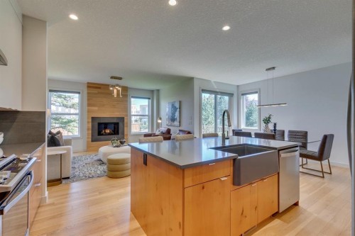 69 Shawnee Green Sw, Calgary, AB - Indoor Photo Showing Kitchen With Fireplace