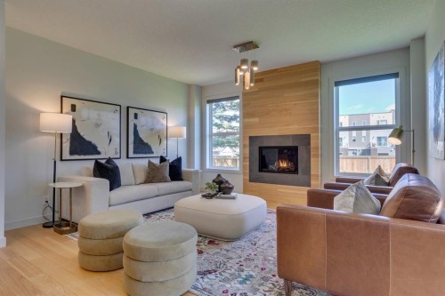 69 Shawnee Green Sw, Calgary, AB - Indoor Photo Showing Living Room With Fireplace