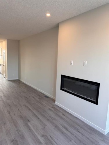 25 Setonvista Gate Se, Calgary, AB - Indoor Photo Showing Living Room With Fireplace