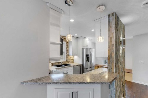 4 Mckernan Place Se, Calgary, AB - Indoor Photo Showing Kitchen With Double Sink With Upgraded Kitchen