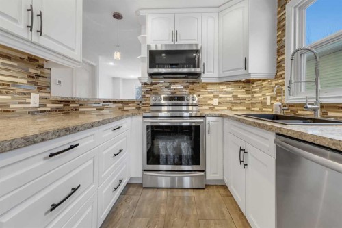 4 Mckernan Place Se, Calgary, AB - Indoor Photo Showing Kitchen With Double Sink With Upgraded Kitchen