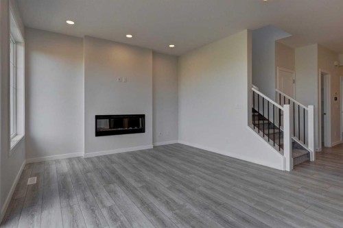 98 Silver Spruce Road Sw, Calgary, AB - Indoor Photo Showing Living Room With Fireplace