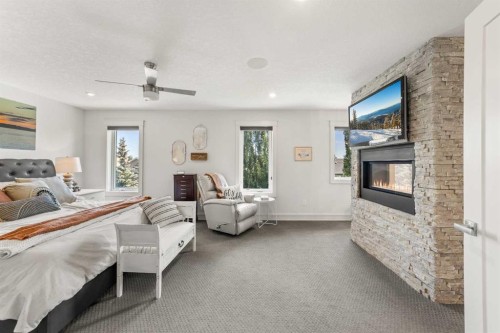 71 Harrison Green, Olds, AB - Indoor Photo Showing Bedroom With Fireplace