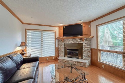 115 Strathaven Circle Sw, Calgary, AB - Indoor Photo Showing Living Room With Fireplace