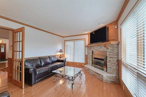 115 Strathaven Circle Sw, Calgary, AB - Indoor Photo Showing Living Room With Fireplace