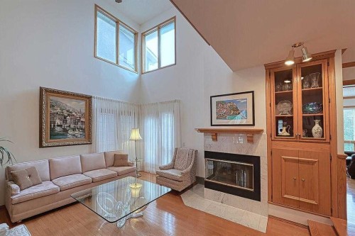 115 Strathaven Circle Sw, Calgary, AB - Indoor Photo Showing Living Room With Fireplace