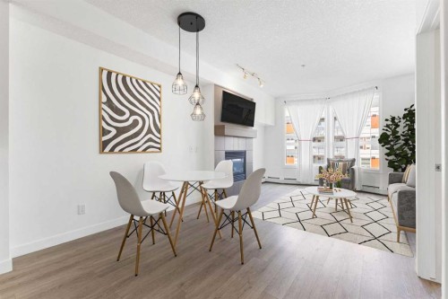 302-2420 34 Avenue Sw, Calgary, AB - Indoor Photo Showing Dining Room With Fireplace