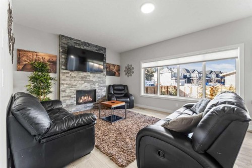 804 Shawnee Terrace Sw, Calgary, AB - Indoor Photo Showing Living Room With Fireplace