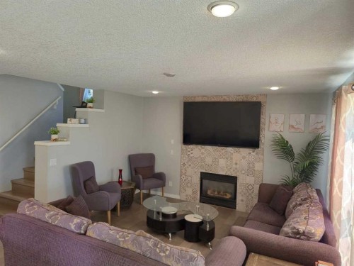 422 Bridlecreek Green Sw, Calgary, AB - Indoor Photo Showing Living Room With Fireplace