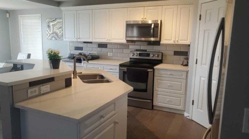 422 Bridlecreek Green Sw, Calgary, AB - Indoor Photo Showing Kitchen With Double Sink