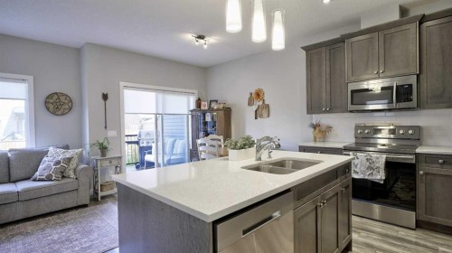 135 Reunion Loop Nw, Airdrie, AB - Indoor Photo Showing Kitchen With Double Sink