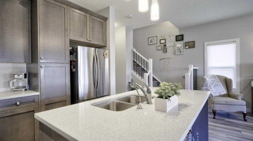 135 Reunion Loop Nw, Airdrie, AB - Indoor Photo Showing Kitchen With Double Sink