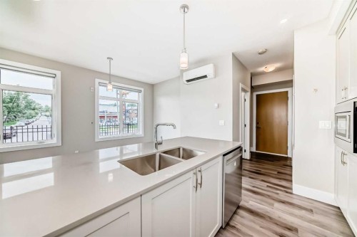 115-1702 17 Avenue Sw, Calgary, AB - Indoor Photo Showing Kitchen With Double Sink
