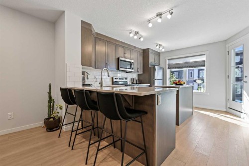 107-474 Seton Circle Se, Calgary, AB - Indoor Photo Showing Kitchen With Stainless Steel Kitchen With Upgraded Kitchen