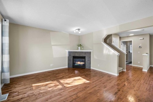 89 Mckenzie Towne Drive Se, Calgary, AB - Indoor Photo Showing Living Room With Fireplace
