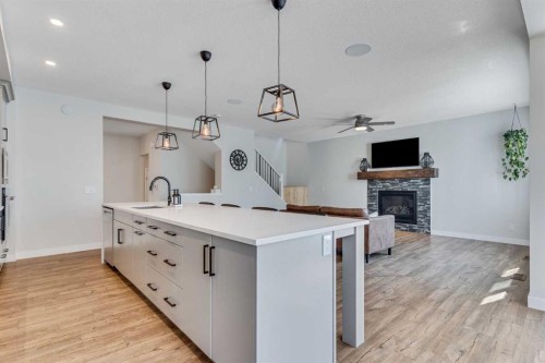 99 Legacy Glen Terrace Se, Calgary, AB - Indoor Photo Showing Kitchen With Fireplace