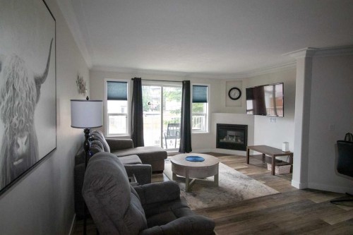 103-604 19 Street Se, High River, AB - Indoor Photo Showing Living Room With Fireplace