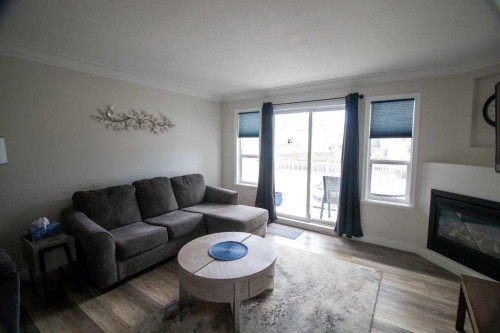 103-604 19 Street Se, High River, AB - Indoor Photo Showing Living Room With Fireplace