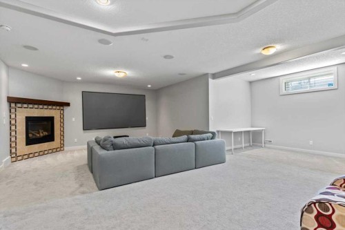 13 Sage Hill Landing Nw, Calgary, AB - Indoor Photo Showing Basement With Fireplace