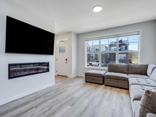 235 Aquila Way Nw, Calgary, AB - Indoor Photo Showing Living Room With Fireplace