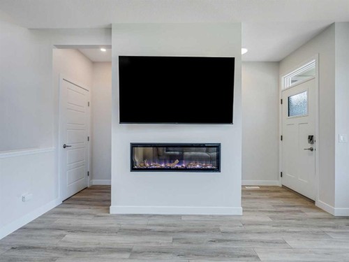 235 Aquila Way Nw, Calgary, AB - Indoor Photo Showing Living Room With Fireplace