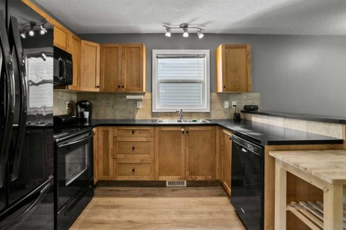 701 Prairie Sound Circle Nw, High River, AB - Indoor Photo Showing Kitchen With Double Sink
