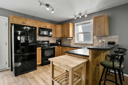 701 Prairie Sound Circle Nw, High River, AB - Indoor Photo Showing Kitchen With Double Sink