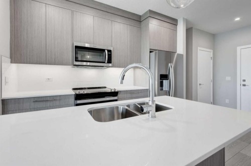 2215-6 Merganser Drive West, Chestermere, AB - Indoor Photo Showing Kitchen With Double Sink With Upgraded Kitchen