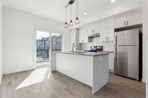 203-24 Rivercrest Drive, Cochrane, AB - Indoor Photo Showing Kitchen With Stainless Steel Kitchen