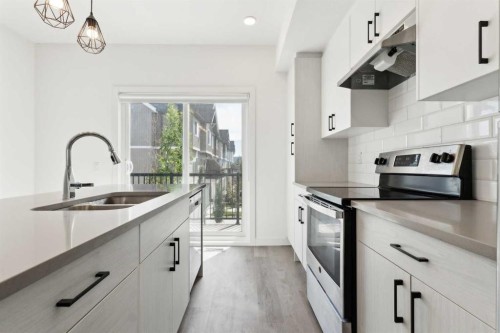 203-24 Rivercrest Drive, Cochrane, AB - Indoor Photo Showing Kitchen With Double Sink With Upgraded Kitchen