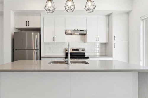 703-24 Rivercrest Drive, Cochrane, AB - Indoor Photo Showing Kitchen With Stainless Steel Kitchen With Double Sink With Upgraded Kitchen