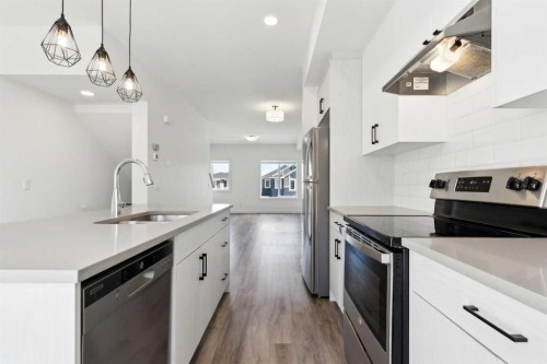 703-24 Rivercrest Drive, Cochrane, AB - Indoor Photo Showing Kitchen With Stainless Steel Kitchen With Upgraded Kitchen