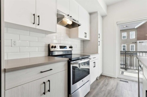 703-24 Rivercrest Drive, Cochrane, AB - Indoor Photo Showing Kitchen With Upgraded Kitchen