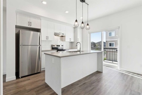 703-24 Rivercrest Drive, Cochrane, AB - Indoor Photo Showing Kitchen With Stainless Steel Kitchen With Upgraded Kitchen