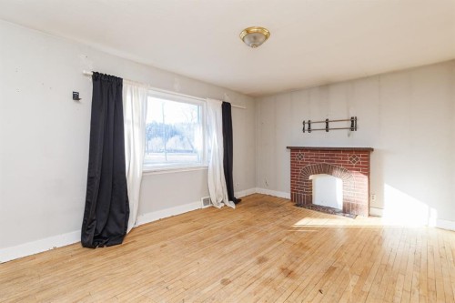 2820 Parkdale Boulevard Nw, Calgary, AB - Indoor Photo Showing Living Room With Fireplace
